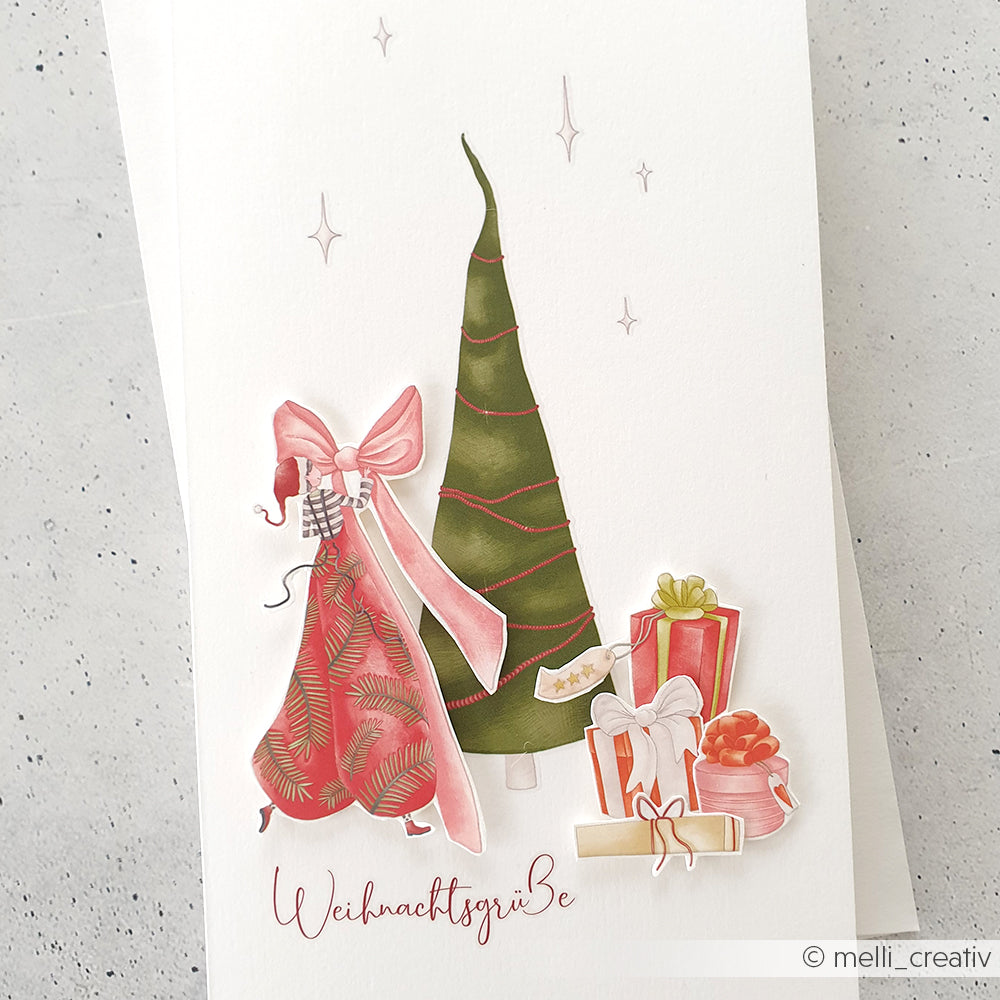 Festliche Illustration mit Weihnachtsbaum, Geschenken, rotem Kleid mit Schleife und Weihnachtsgrüße-Text - perfekt für Transferfolien Basteln oder mit Rub-On-Motiven von Alexandra Renke für eine persönliche Note zu Weihnachten.