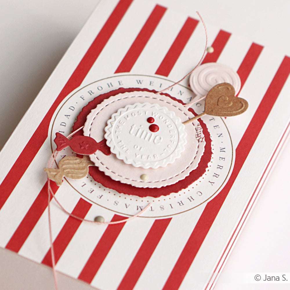 Handgefertigte Weihnachtskarte von Alexandra Renke mit roten und weißen Streifen, Herzen und geschichteten Kreisen, die mit hochwertigen Designpapieren und dem Cut & Emboss Folder Stanzsystem gestaltet wurden.