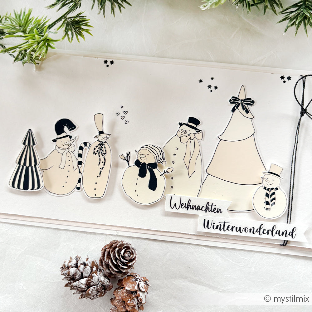 Handgefertigte Karte von Alexandra Renke mit Schneemännern, Weihnachtsbäumen, Tannenzapfen und "Weihnachten Winterwonderland" - ideal für Bastelprojekte oder um Weihnachtsglück Transferfolien-Charme in Ihre Festtagsgrüße zu bringen.