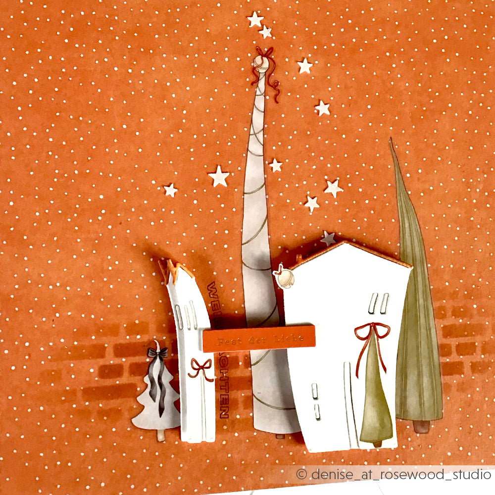 Skurrile illustrierte Winterhäuser und -bäume vor einem orangefarbenen, sternenübersäten und verschneiten Hintergrund von Alexandra Renke - ideal für Bastelprojekte zu Weihnachten oder um Ihren Weihnachtsbasteleien einen Hauch von Rub-On Weihnachtszauber zu verleihen.