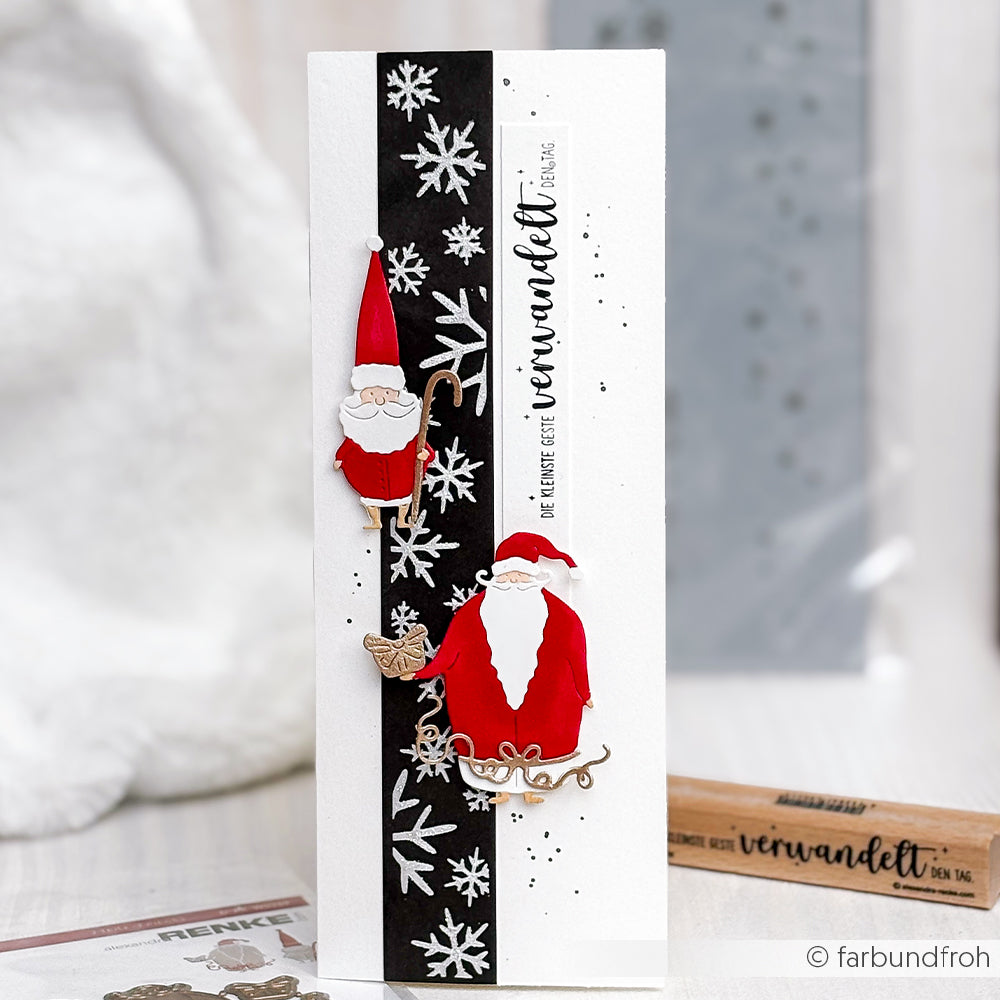 Handgemachte Weihnachtskarte von Alexandra Renke mit Weihnachtsmannfiguren, Schneeflocken und dem Text "verwandelt" auf einem schwarzen Streifen. Verwendet die Schablone Musterstreifen Schneefall für einzigartige Details - ideal für Schablonen Papierprojekte.