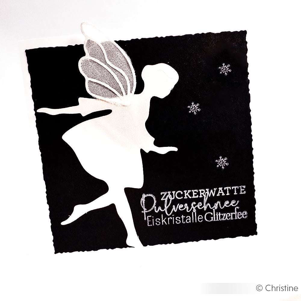 Weiße Feen-Silhouette mit glitzernden Flügeln auf Schwarz, umgeben von Schneeflocken und deutschem Festtagstext - perfekt für Winterkarten mit Alexandra Renke's Winterschnee Clear Stamp oder Photopolymer-Stempel-Designs.