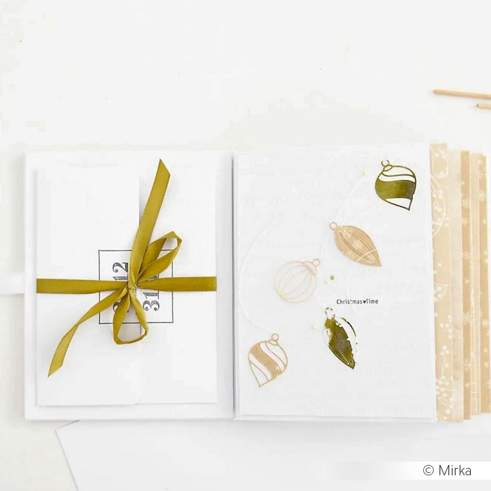 Offene Karte mit goldenem Band auf der linken Seite und Weihnachtskugeln auf der rechten Seite, mit dem Spruch "Frohe Feiertage", gestempelt mit Alexandra Renke Clear Stamp auf einem hellen Hintergrund.