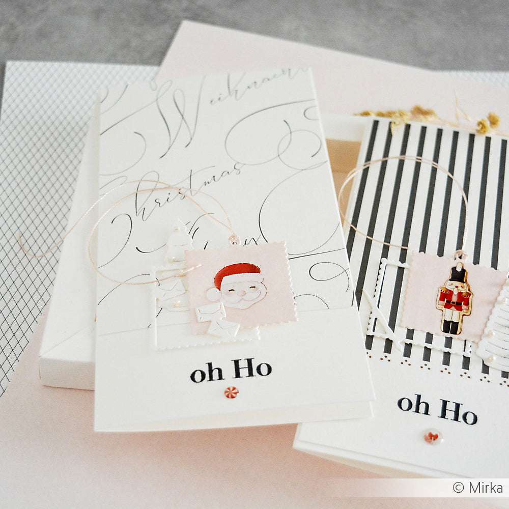 Zwei elegante Weihnachtskarten mit "Oh Ho"-Text, Weihnachtsmann und Nussknacker-Ornamenten, erstellt mit Alexandra Renke Klarsichtstempeldesigns auf pastellfarbenem Hintergrund.