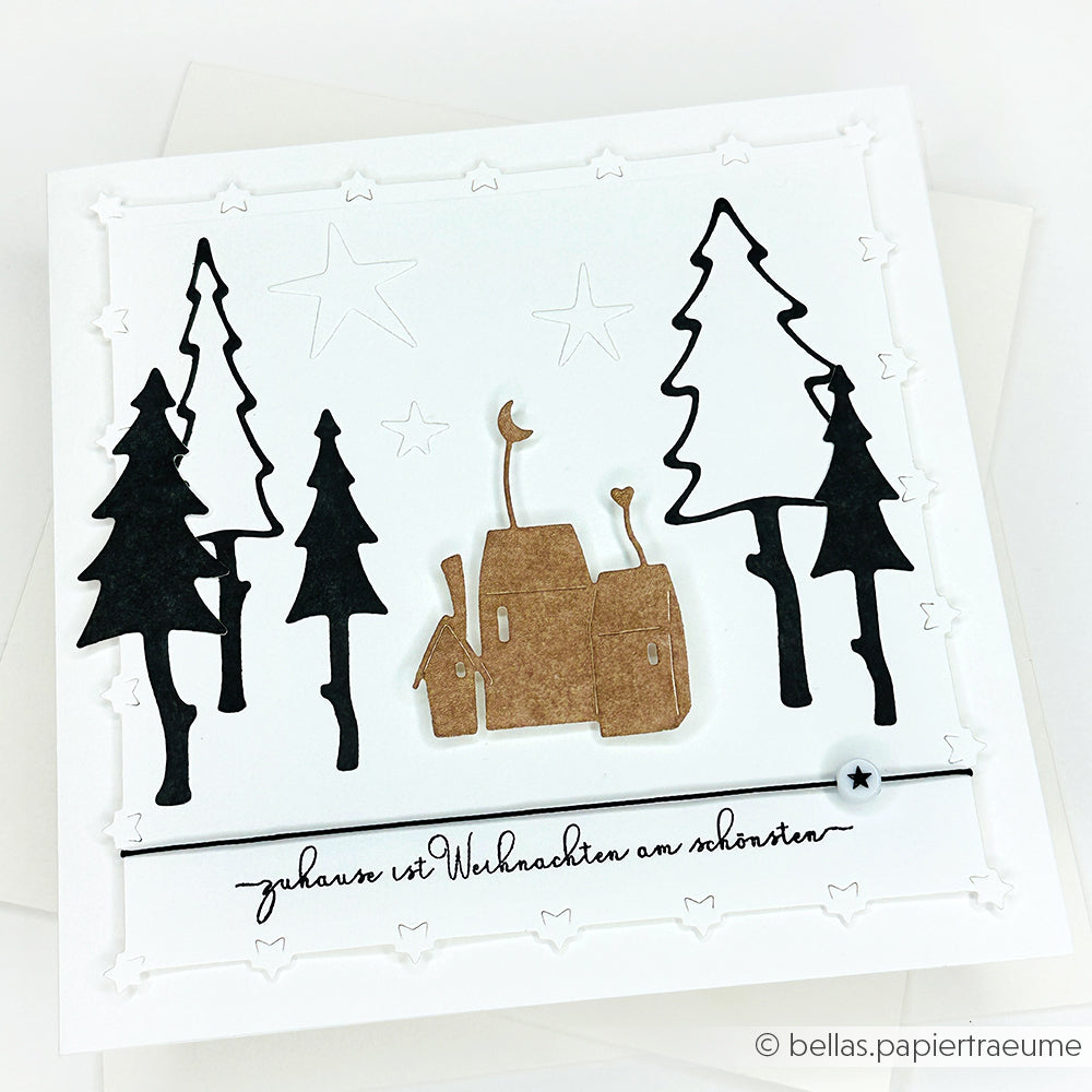 Handgemachte Weihnachtskarte mit Bäumen, Sternen und Häusern, gestaltet mit Alexandra Renke's Clear Stamp Photopolymer Stempel. Deutscher Text: "Zuhause ist Weihnachten am schönsten.