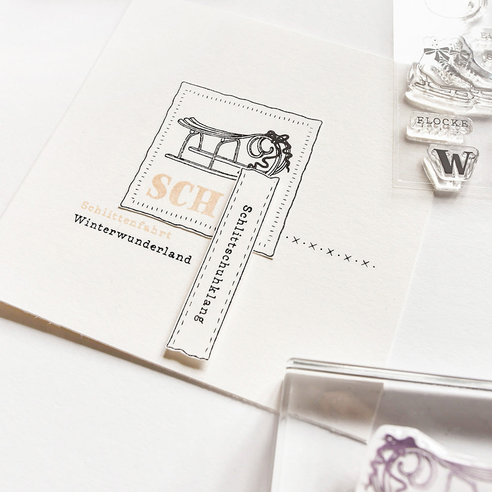 Eine Karte mit einem alten Schlitten und deutschem Text, teilweise überlagert mit Alexandra Renke Schneemotive Photopolymer-Klarsichtstempeln.