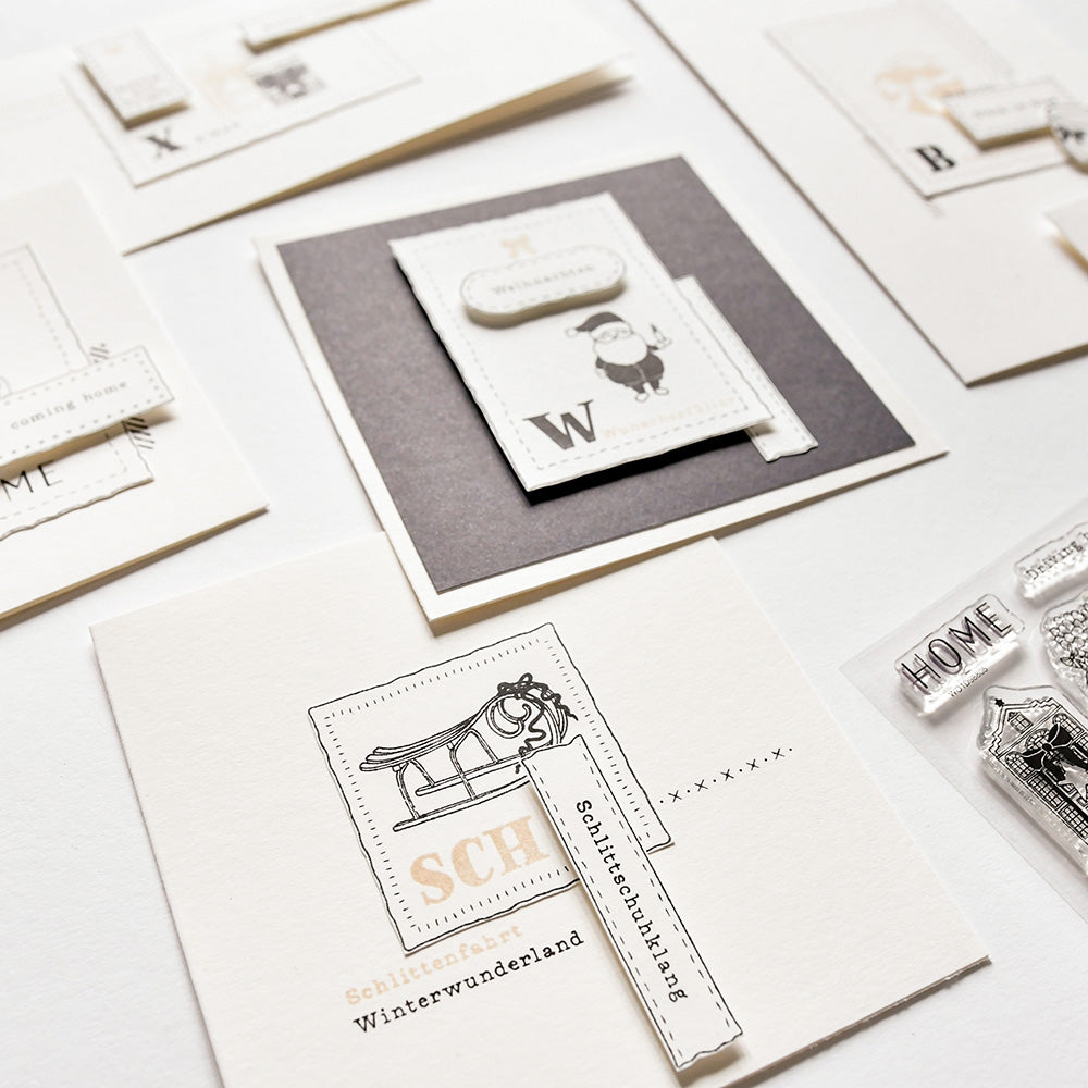 Handgefertigte Grußkarten von Alexandra Renke mit minimalistischen Winter- und Wohnthemen, mit zarten Schneemotiven, die mit Photopolymer-Klarsichtstempeln auf einer weißen Oberfläche gestaltet wurden.