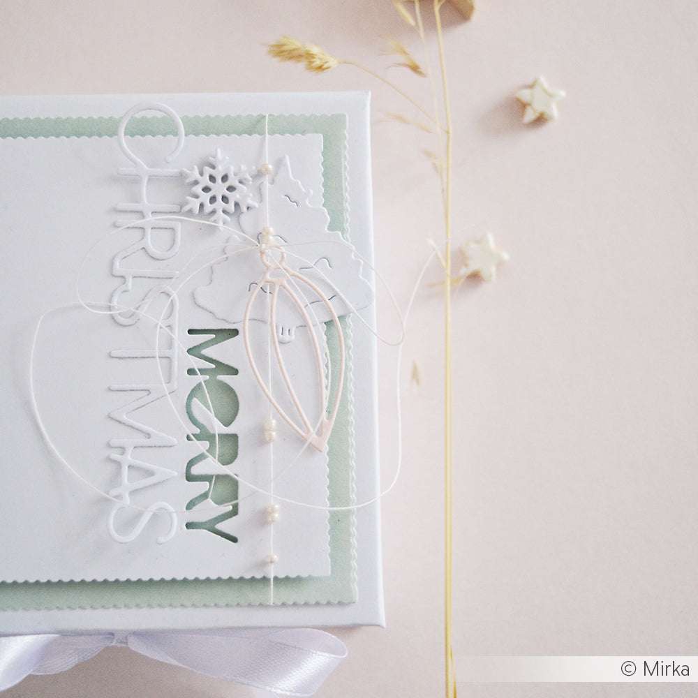 Weiße Weihnachtskarte von Alexandra Renke mit dem Text "Frohe Weihnachten", Schneeflocke, Schleife und weißer Kordeldekoration, festlich gestaltet mit den Dies und der Motivstanze Baumkugel Stanzsysteme.