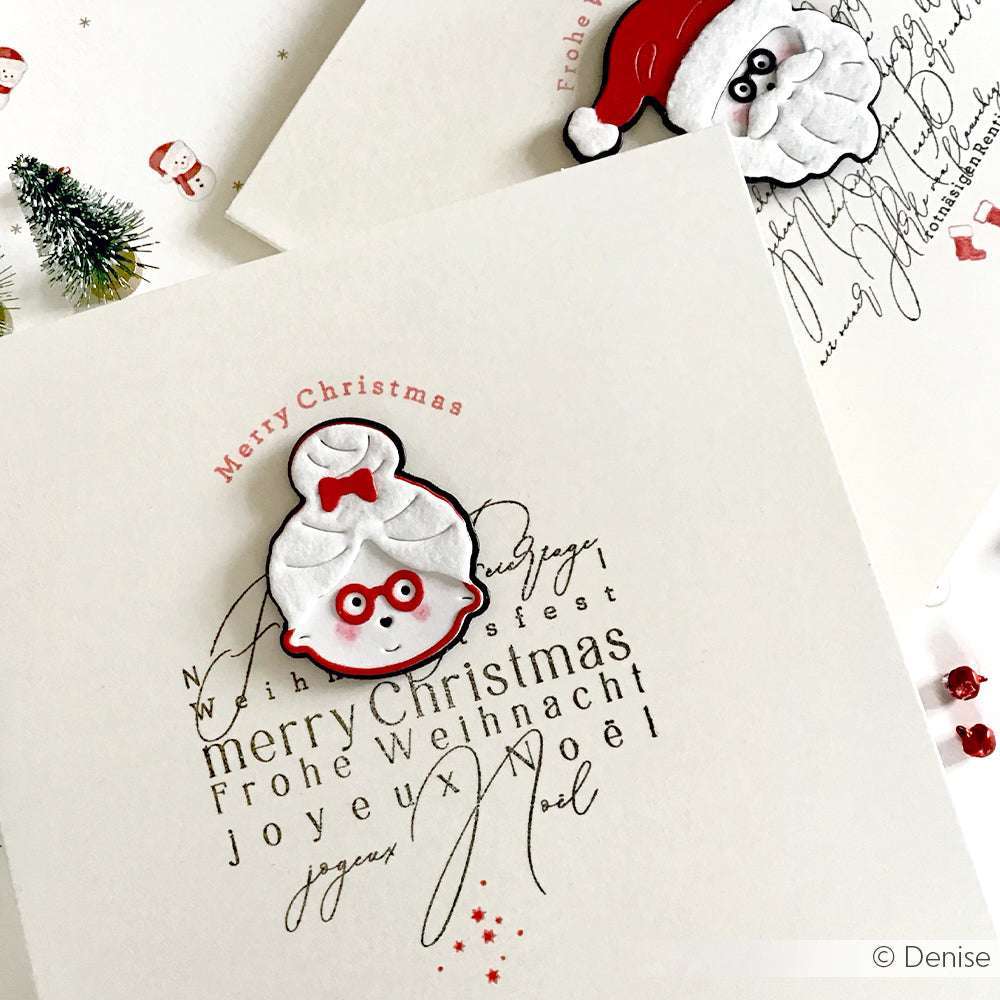 Handgemachte Weihnachtskarten von Alexandra Renke, gestaltet mit festlichen Designpapieren und einer Motivstanze Schicht-Weihnachtsfrau, die den Weihnachtsmann und eine niedliche weiße Figur mit roter Brille zeigt.