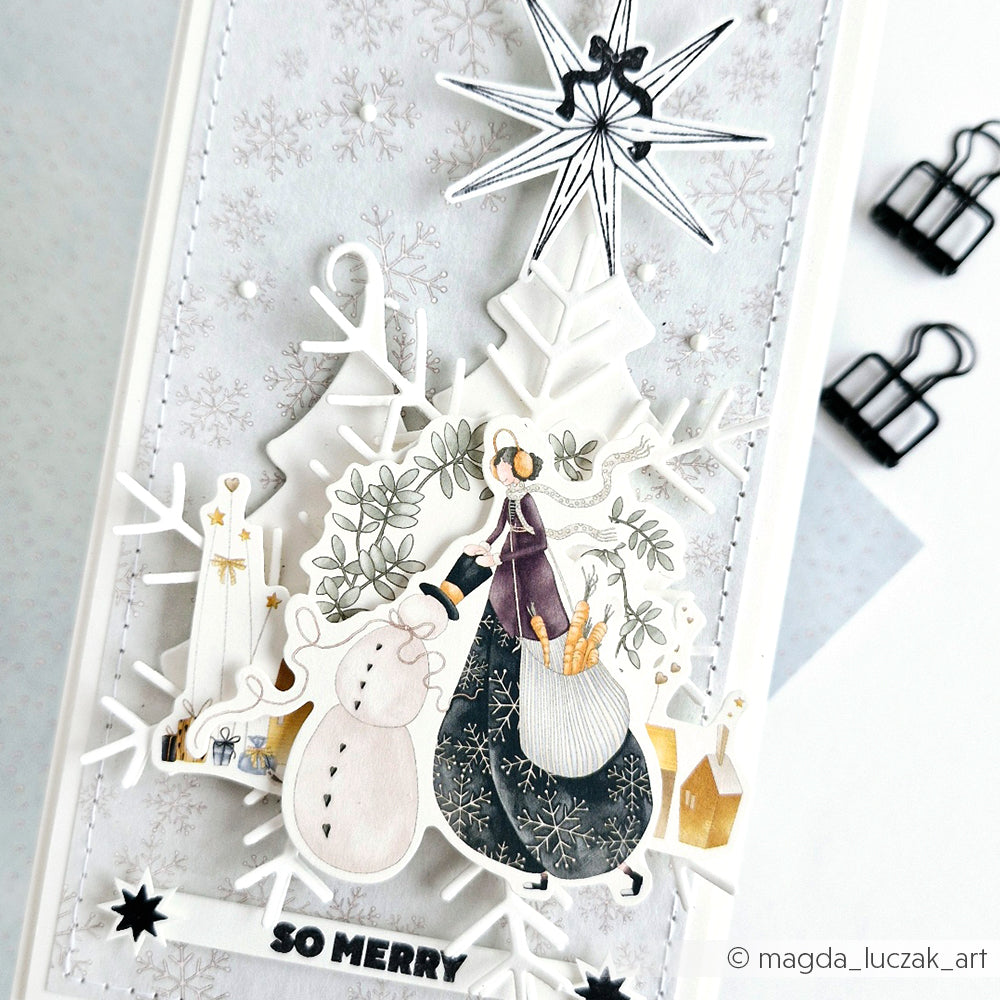 Eine festliche, handgefertigte Karte von Alexandra Renke mit einem Schneemann, einer Frau in einem Kleid und Schneeflocken, die mit Stanzen für Designpapier hergestellt wurden, sowie einer fröhlichen "SO MERRY"-Botschaft.