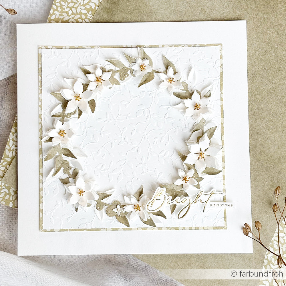 Eine quadratische Grußkarte mit einem Kranz aus floralen Winterkonfetti vor einem geprägten weißen Hintergrund und dem Schriftzug „Bright Christmas“.