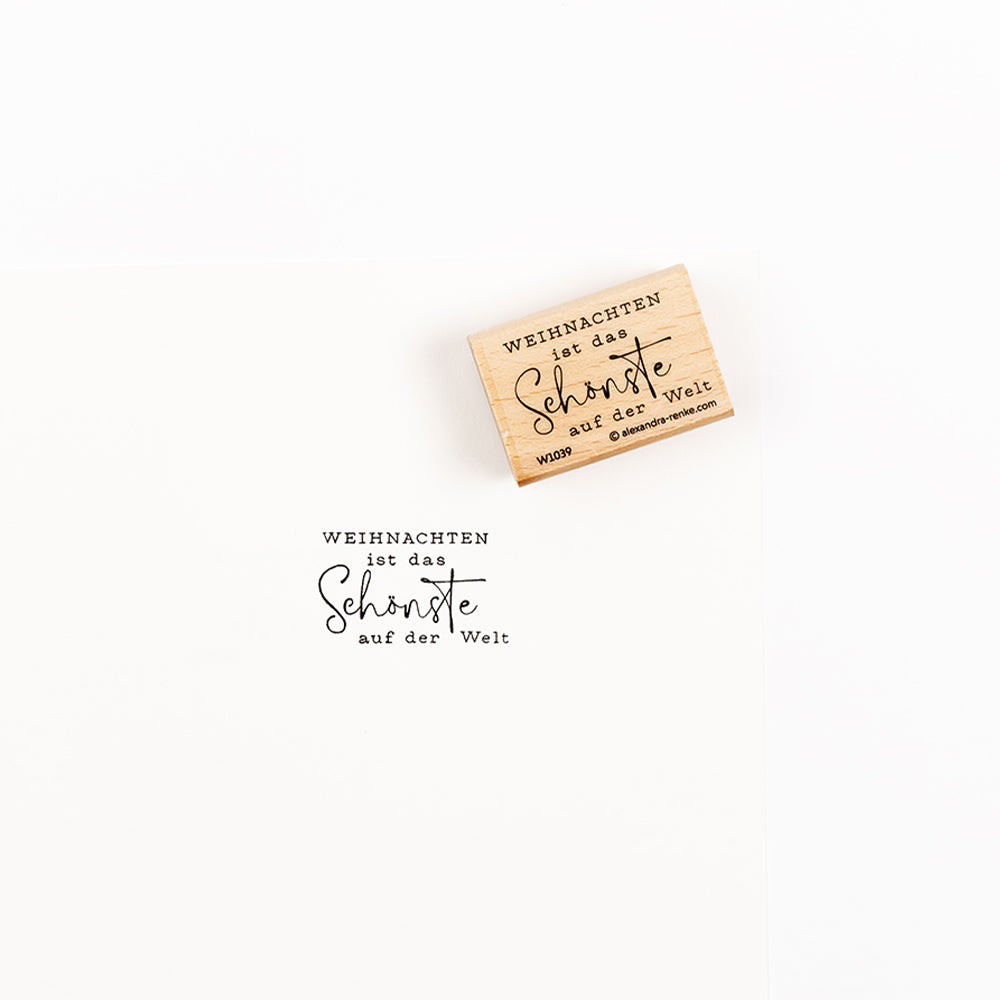 Ein Weihnachtsstempel aus Holz mit dem Abdruck Weihnachten ist das Schönste auf der Welt.