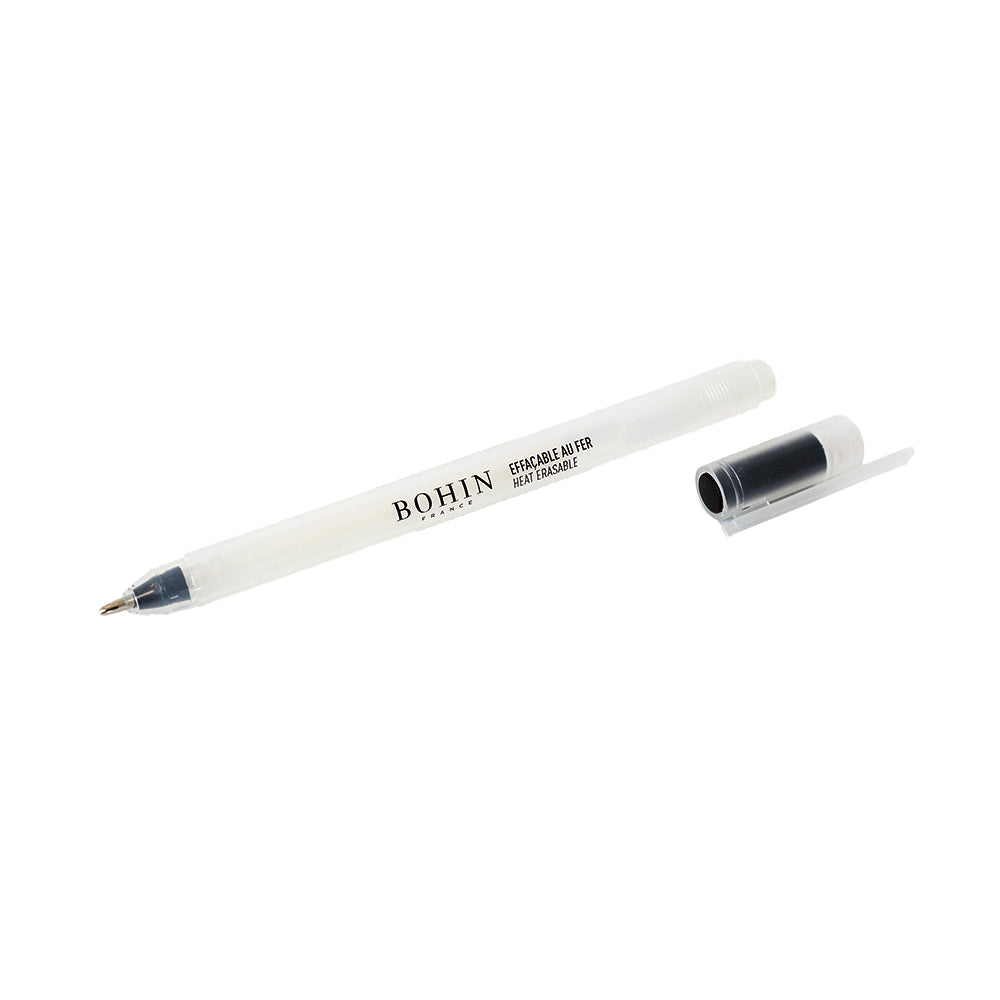 Durchsichtiger, abwischbarer Stift von BOHIN France mit schwarzer Kappe; sowohl der Stift als auch die Kappe liegen auf einem weißen Hintergrund. Dieser weiße, wärmeempfindliche Stift mit Gel-Tinte von BOHIN France eignet sich hervorragend zum Markieren auf dunklen Stoffen, da sich die Tinte leicht entfernen lässt.
